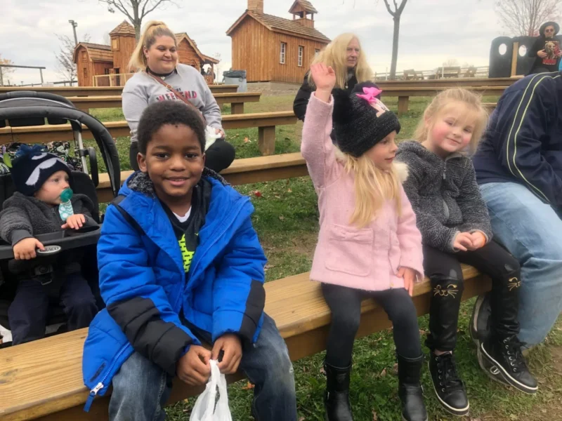 Kids sitting in the farm