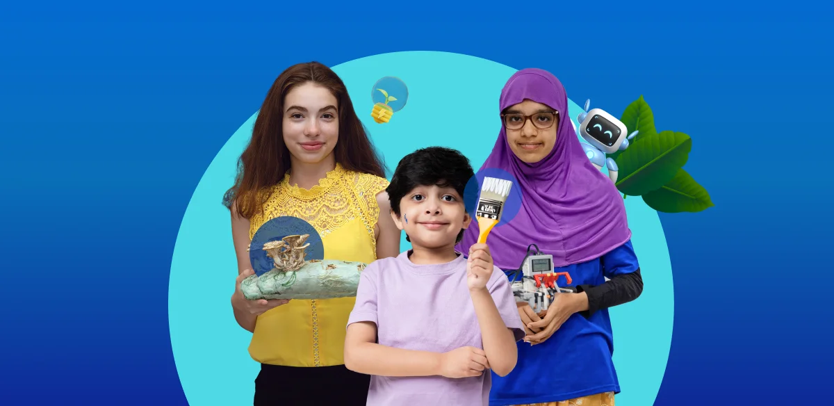 Student with a art project, a boy with a brush and another girl holding a small robot